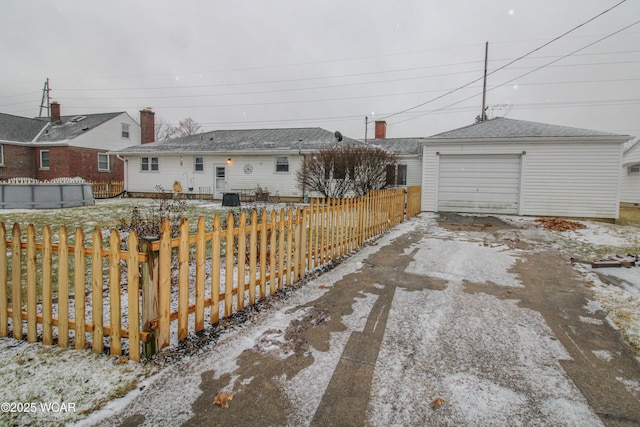 exterior space with an outbuilding and a garage