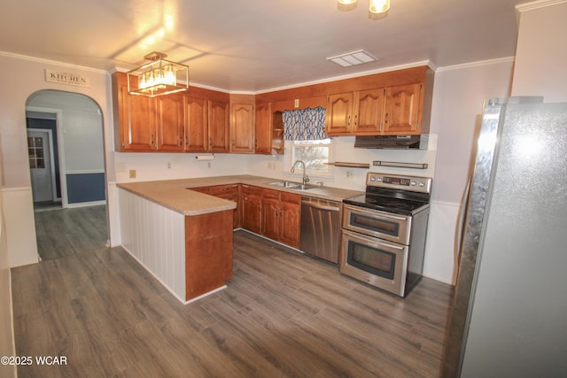 kitchen with crown molding, appliances with stainless steel finishes, sink, and dark wood-type flooring