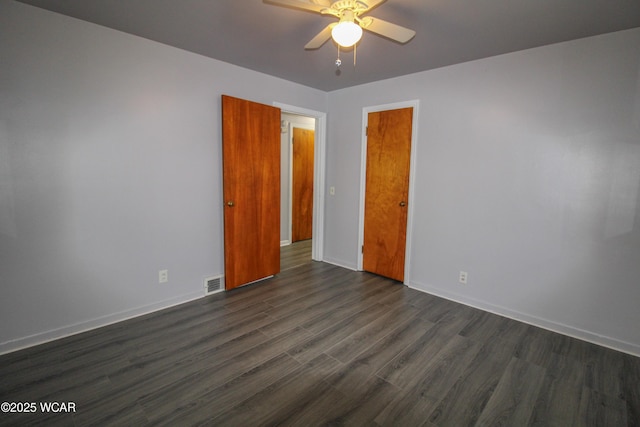 unfurnished room featuring dark hardwood / wood-style floors and ceiling fan