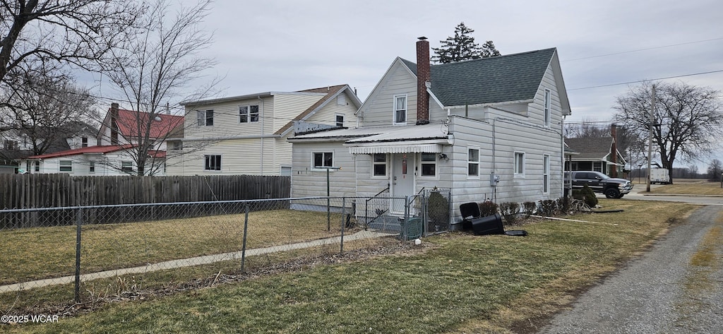 exterior space with a yard, a chimney, and fence