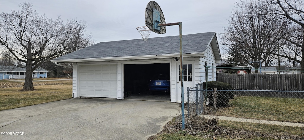 detached garage featuring fence