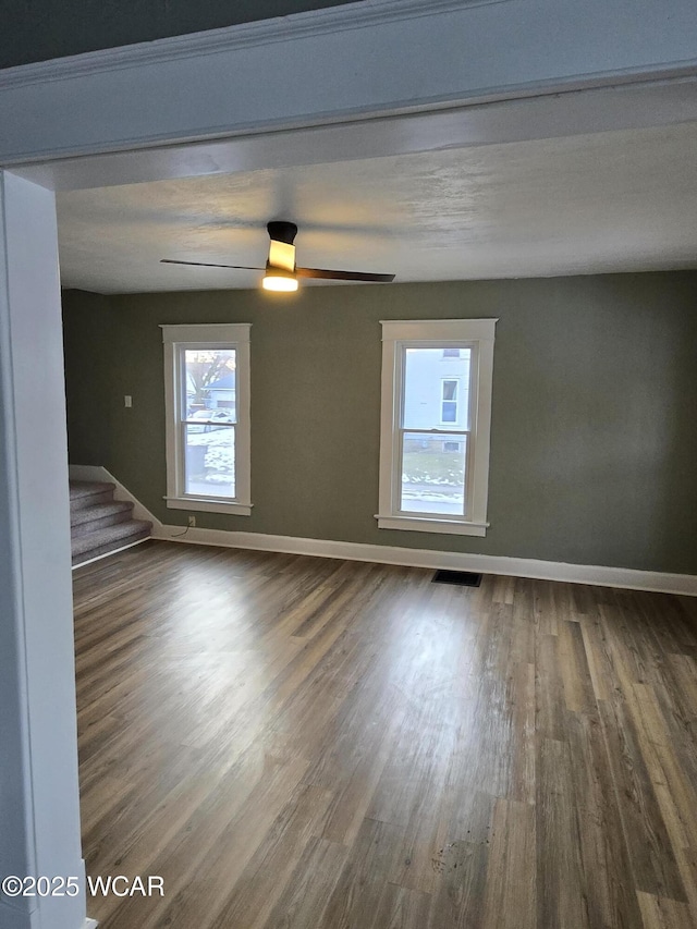 spare room featuring wood-type flooring and ceiling fan