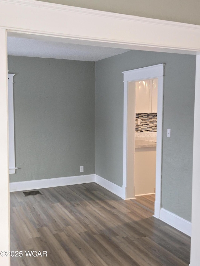 empty room featuring dark hardwood / wood-style floors