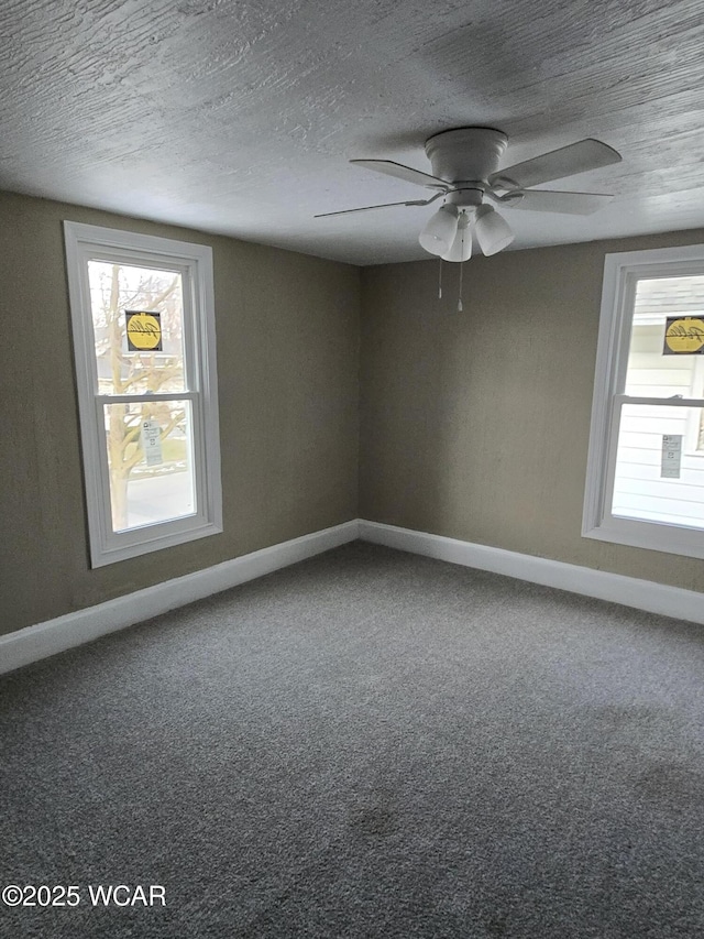 unfurnished room with ceiling fan, carpet floors, and a textured ceiling