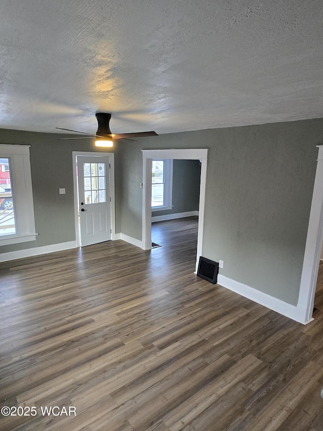 foyer featuring ceiling fan, a textured ceiling, and dark hardwood / wood-style flooring