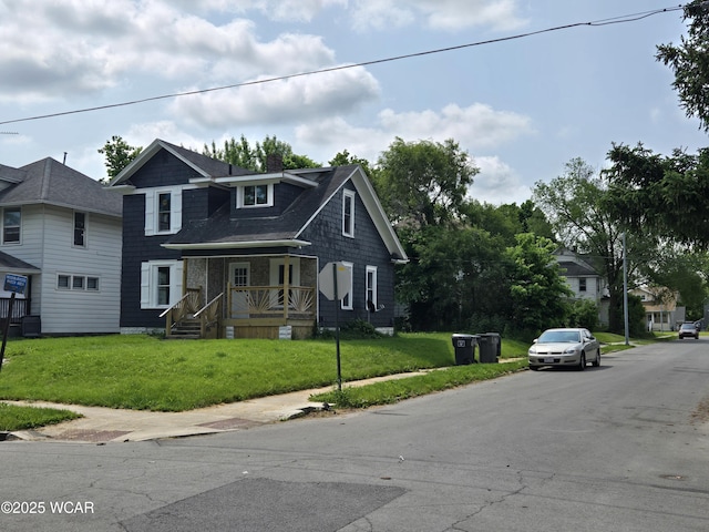 931 Richie Ave, Lima, OH 45805 - view of front of home with a front yard, a chimney, and a shingled roof