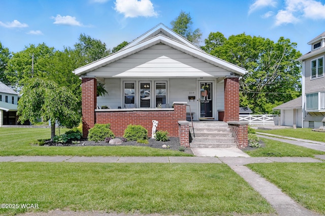 219 N Market St, Kenton, OH 43326 - view of front facade featuring brick siding and covered porch