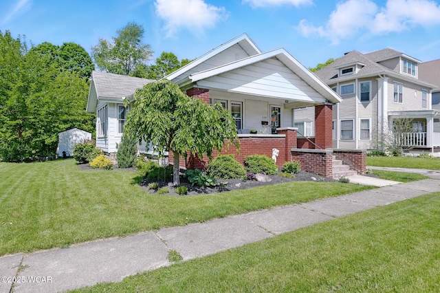 219 N Market St, Kenton, OH 43326 - view of front of home featuring a front yard and a porch