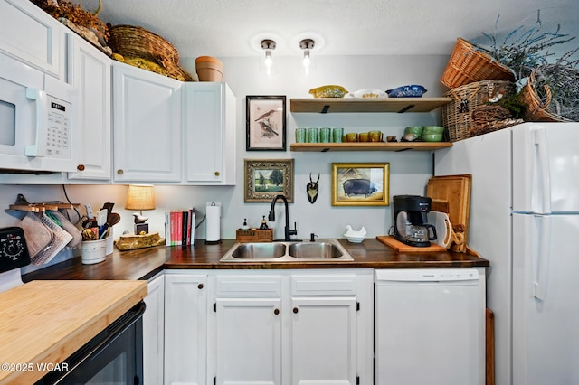 219 N Market St, Kenton, OH 43326 - kitchen with white appliances, a sink, wooden counters, and white cabinets