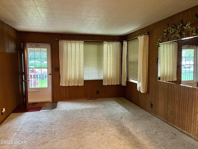 1440 Southwood Dr, Lima, OH 45805 - empty room featuring plenty of natural light, wooden walls, and carpet