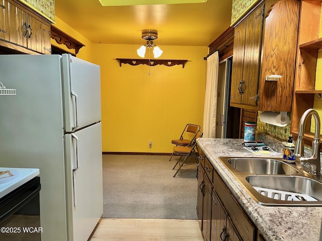 1440 Southwood Dr, Lima, OH 45805 - kitchen with freestanding refrigerator, a sink, electric range, light countertops, and light carpet