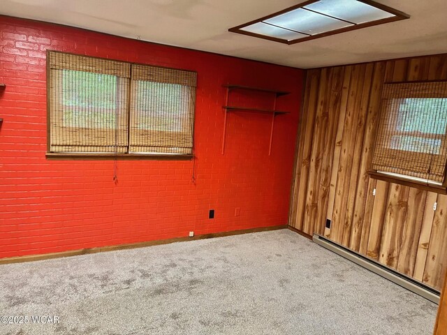 1440 Southwood Dr, Lima, OH 45805 - carpeted empty room with a baseboard heating unit, wooden walls, healthy amount of natural light, baseboards, and attic access