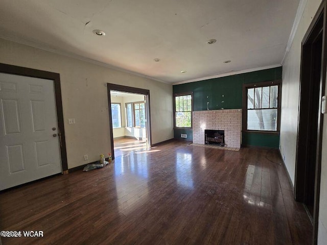 914 Richie Ave, Lima, OH 45805 - unfurnished living room featuring a brick fireplace, baseboards, ornamental molding, and hardwood / wood-style flooring