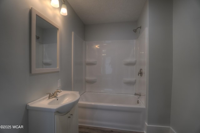430 Hazel Ave, Lima, OH 45801 - full bath featuring a textured ceiling, vanity, tub / shower combination, and wood finished floors