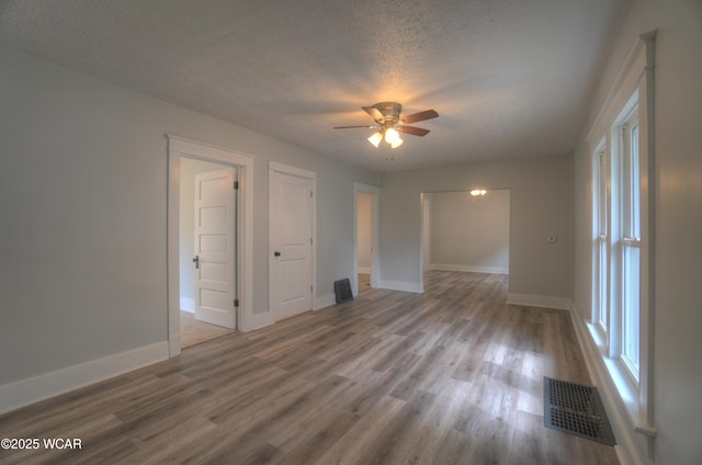 430 Hazel Ave, Lima, OH 45801 - empty room featuring a textured ceiling, wood finished floors, baseboards, and a ceiling fan