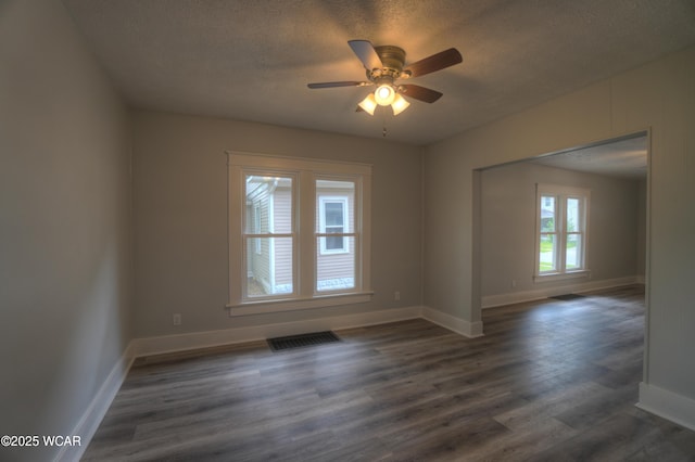 430 Hazel Ave, Lima, OH 45801 - spare room featuring a textured ceiling, ceiling fan, baseboards, and dark wood-style flooring