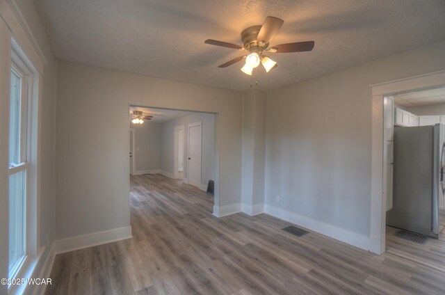 430 Hazel Ave, Lima, OH 45801 - empty room with a ceiling fan, wood finished floors, baseboards, and a textured ceiling