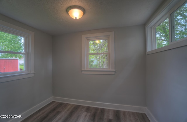 430 Hazel Ave, Lima, OH 45801 - unfurnished room featuring baseboards, dark wood finished floors, and a textured ceiling