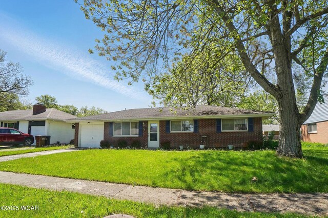 2911 Lakewood Ave, Lima, OH 45805 - ranch-style home featuring a garage, brick siding, a front yard, and driveway