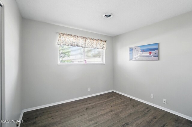 2911 Lakewood Ave, Lima, OH 45805 - spare room with dark wood-type flooring and baseboards