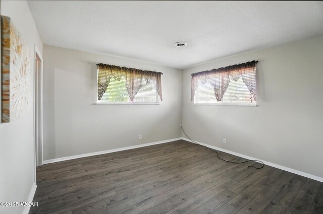 2911 Lakewood Ave, Lima, OH 45805 - empty room featuring dark wood-style flooring and baseboards