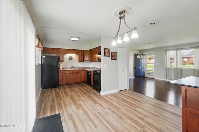2911 Lakewood Ave, Lima, OH 45805 - kitchen featuring black appliances, a sink, baseboards, and light wood-style floors