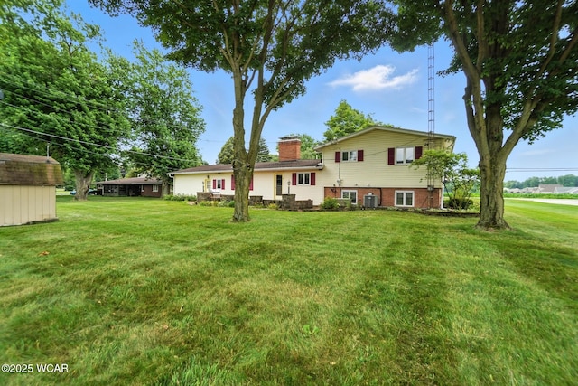 3220 Ft Amanda Rd, Lima, OH 45805 - view of front of home with a front lawn, a chimney, and a storage unit