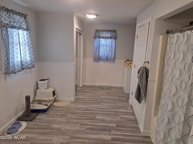 interior space with wainscoting and wood finished floors