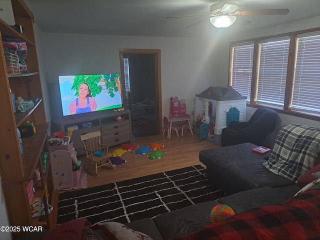 living area featuring wood finished floors and ceiling fan