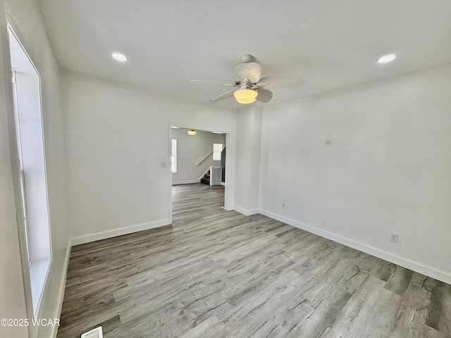 unfurnished room featuring ceiling fan and light wood-type flooring