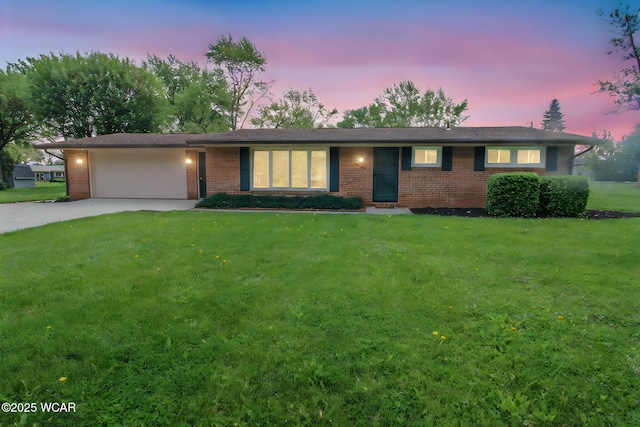 4945 New Haven Dr, Lima, OH 45806 - ranch-style house featuring brick siding, a garage, driveway, and a front lawn