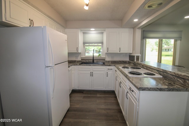 4945 New Haven Dr, Lima, OH 45806 - kitchen featuring freestanding refrigerator, electric cooktop, a peninsula, white cabinetry, and dark wood-type flooring