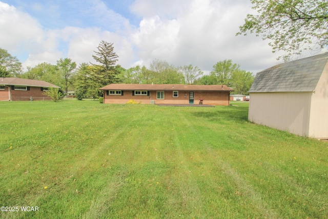 4945 New Haven Dr, Lima, OH 45806 - rear view of house with a lawn and an outbuilding