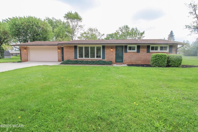 4945 New Haven Dr, Lima, OH 45806 - ranch-style house with brick siding, a garage, concrete driveway, and a front yard