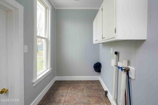 washroom featuring cabinet space, hookup for a washing machine, and baseboards