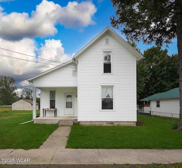 view of front facade featuring covered porch and a front lawn