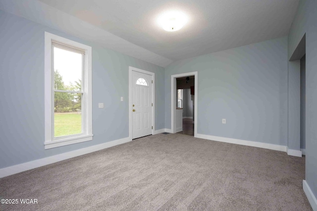 interior space with baseboards and vaulted ceiling