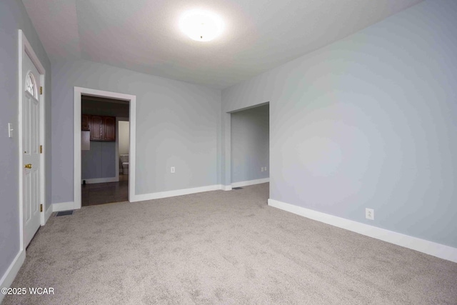 interior space with baseboards and carpet flooring