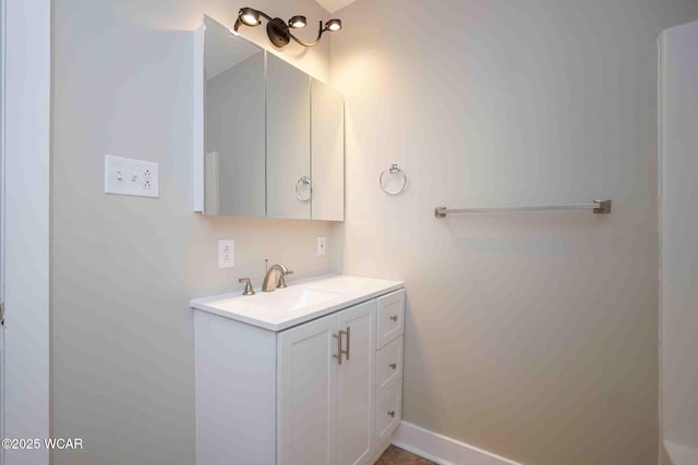 bathroom with vanity and baseboards