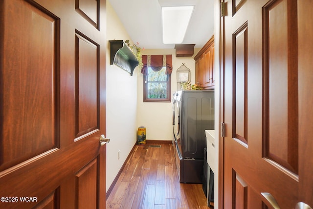 2691 Cremean Rd, Elida, OH 45807 - clothes washing area with dark wood-style floors, washing machine and dryer, baseboards, and cabinet space