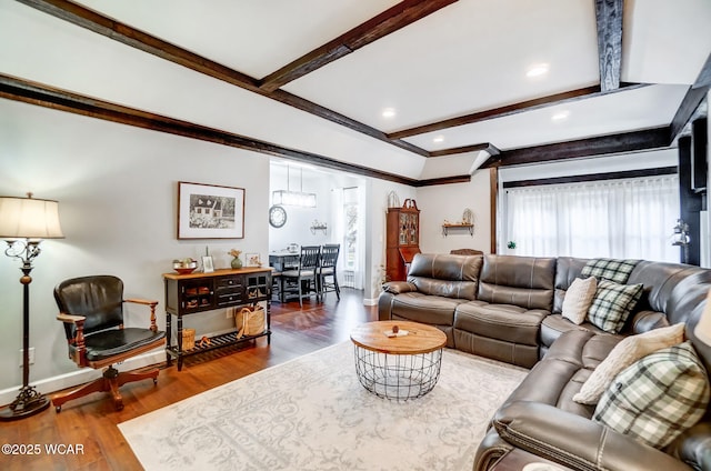 living room with beamed ceiling, baseboards, and wood finished floors