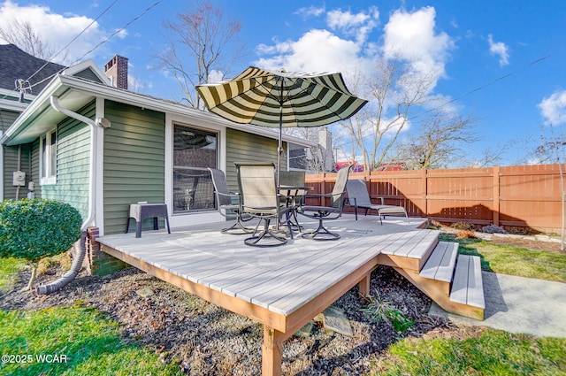 wooden deck featuring outdoor dining area and fence