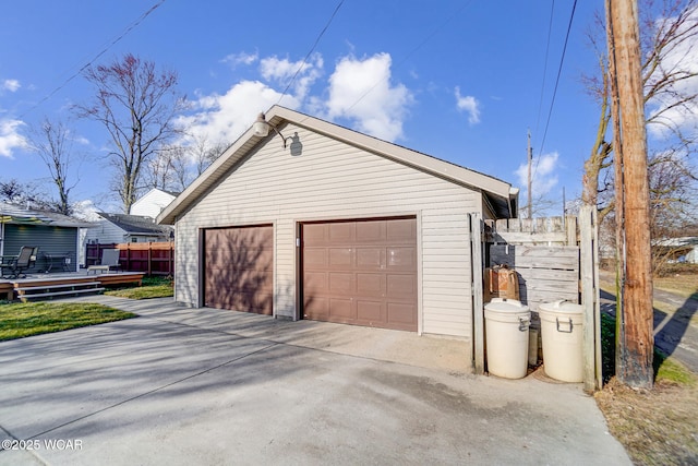 detached garage featuring fence