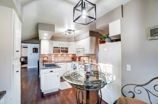 kitchen featuring white appliances, open shelves, a sink, white cabinets, and backsplash