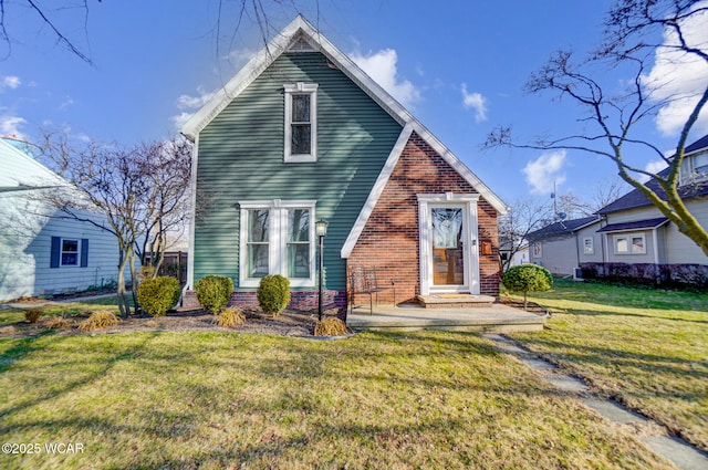 view of front of house with a front yard and brick siding