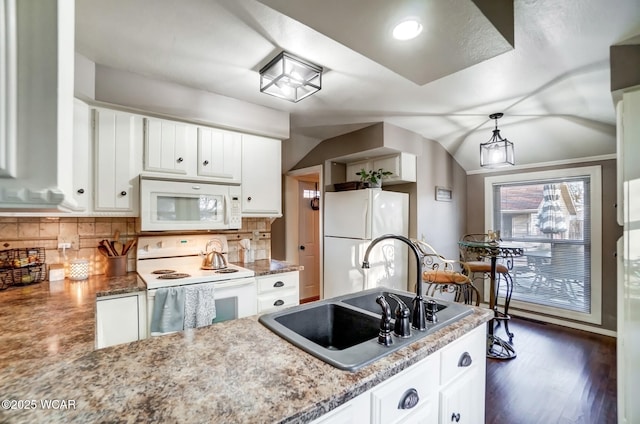 kitchen with backsplash, vaulted ceiling, white appliances, white cabinetry, and a sink