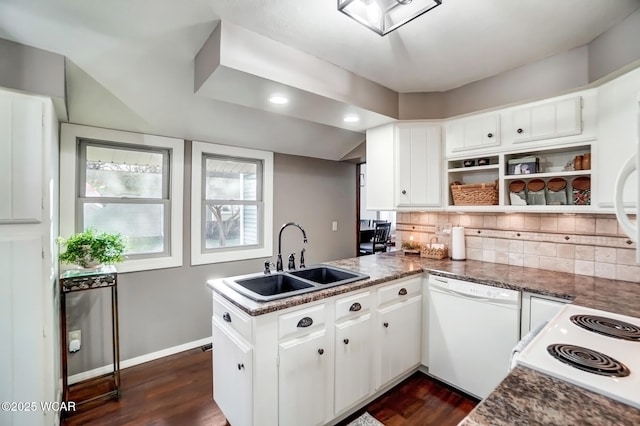 kitchen featuring dishwasher, decorative backsplash, a peninsula, dark wood-style floors, and a sink