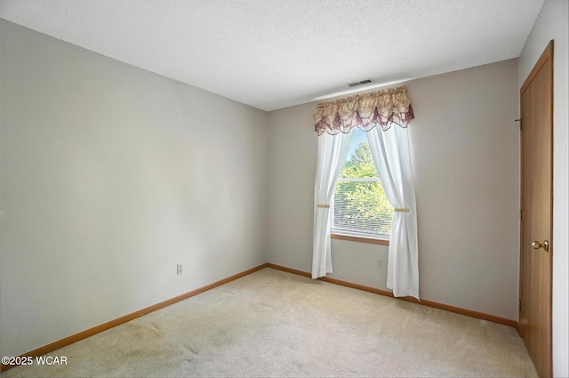 807 Centerfield Dr, Paulding, OH 45879 - spare room featuring light carpet and a textured ceiling