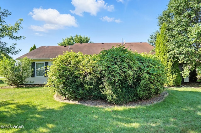 807 Centerfield Dr, Paulding, OH 45879 - back of house featuring a yard and a shingled roof