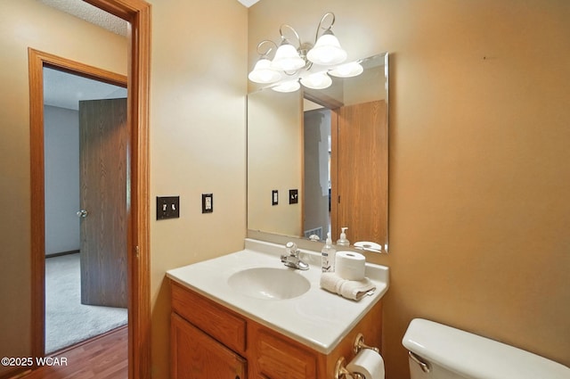 807 Centerfield Dr, Paulding, OH 45879 - bathroom featuring a chandelier, vanity, and wood finished floors